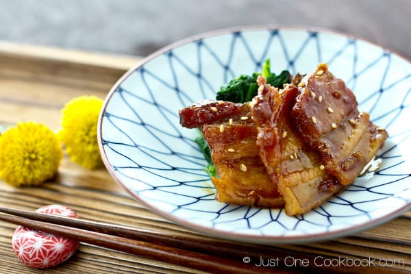 Honey Pork Belly III Honey Pork Belly and spinach on a plate.