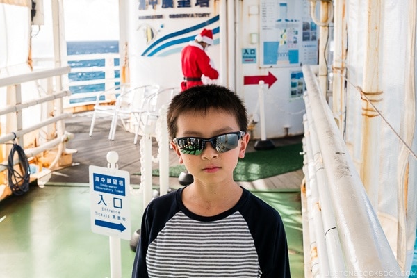 child standing at the entrance to underwater observatory at Busena Marine Park - Okinawa Travel Guide | justonecookbook.com