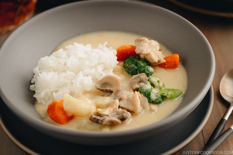 A gray bowl containing Japanese Cream Stew (White Stew) with chicken and vegetables in a savory thick white sauce.