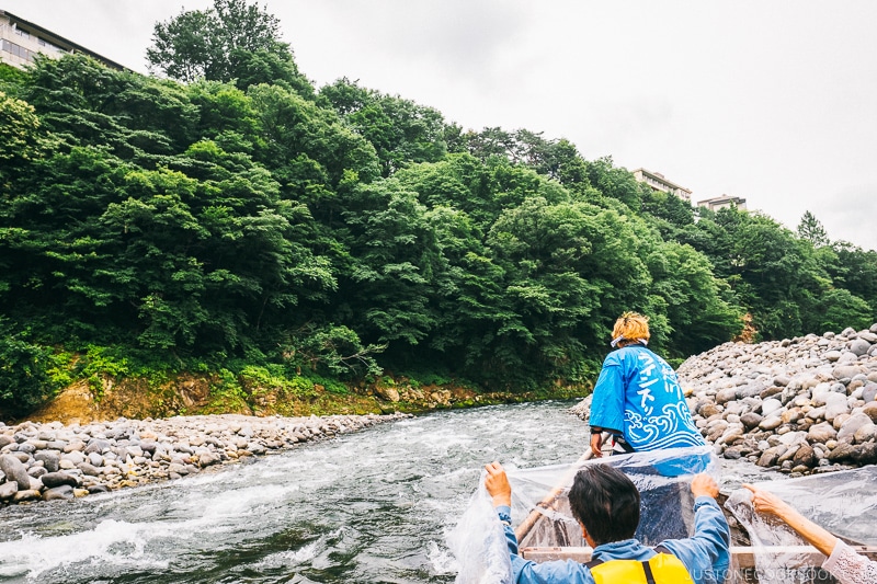 riders holding up plastic tarp on the boat - Nikko Travel Guide : Kinugawa Onsen | www.justonecookbook.com