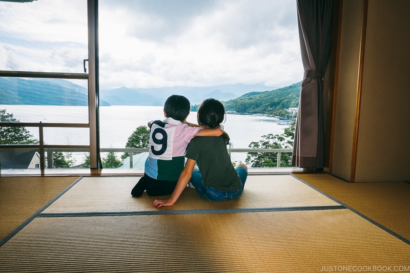 two children looking at Lake Chuzenji from room window at Hoshino Resorts KAI Nikko - Things to do around Lake Chuzenji | www.justonecookbook.com