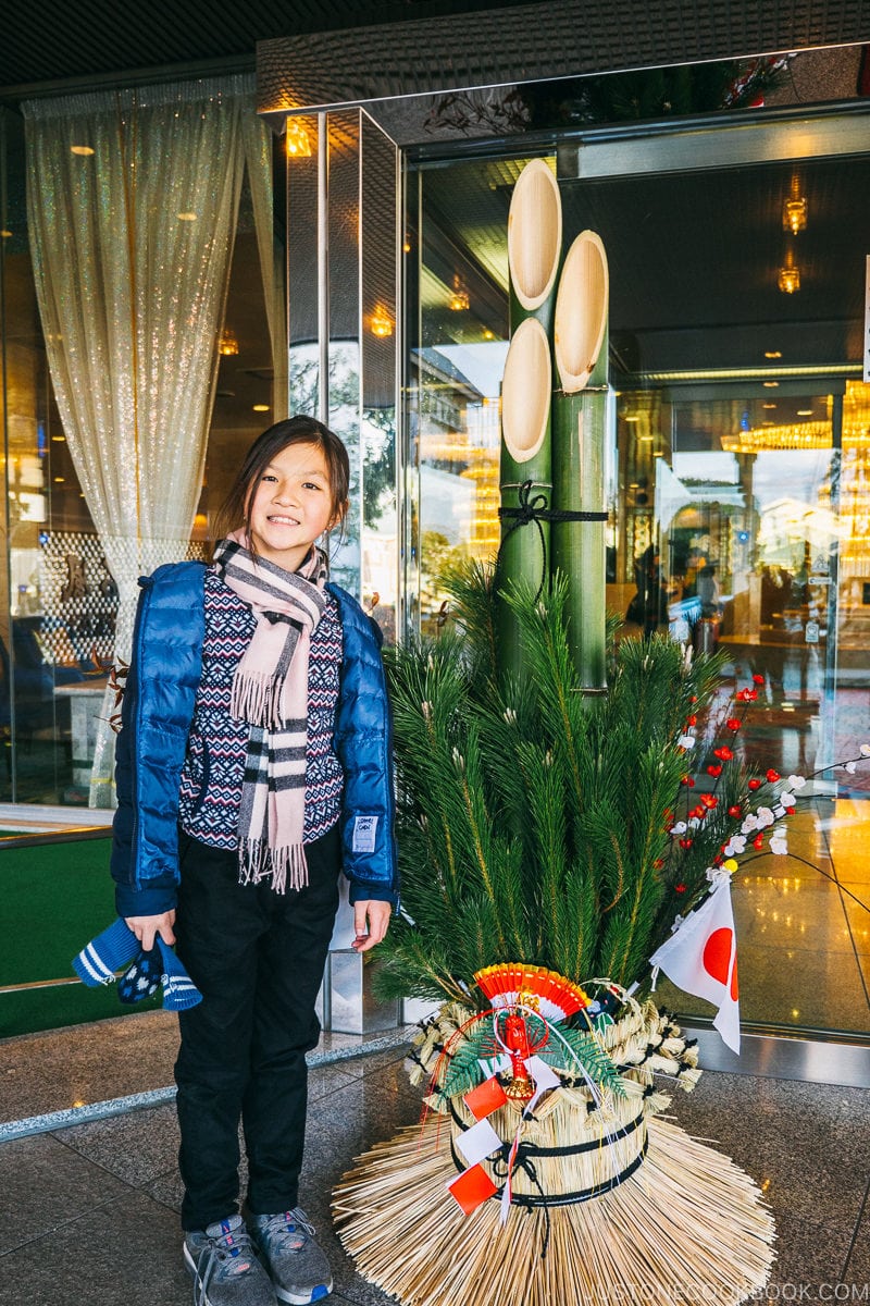 child standing next to kado matsu - Celebrate New Year at Isawa Onsen in Yamanishi | www.justonecookbook.com 