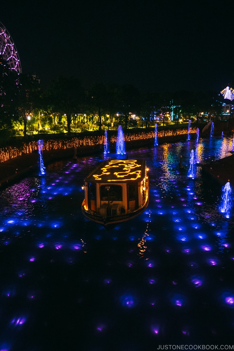 a boat in the canal lite up at night