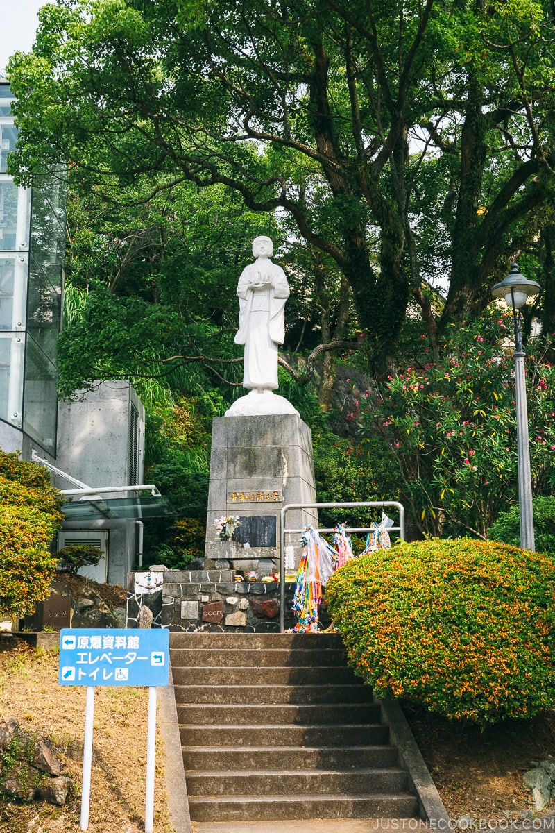 statue of praying child on top of the steps