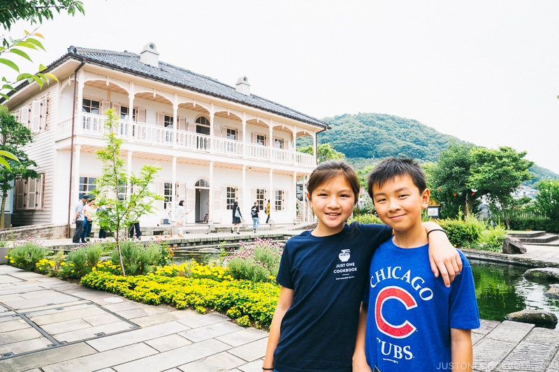 two children in front of former Mitsubishi dock house
