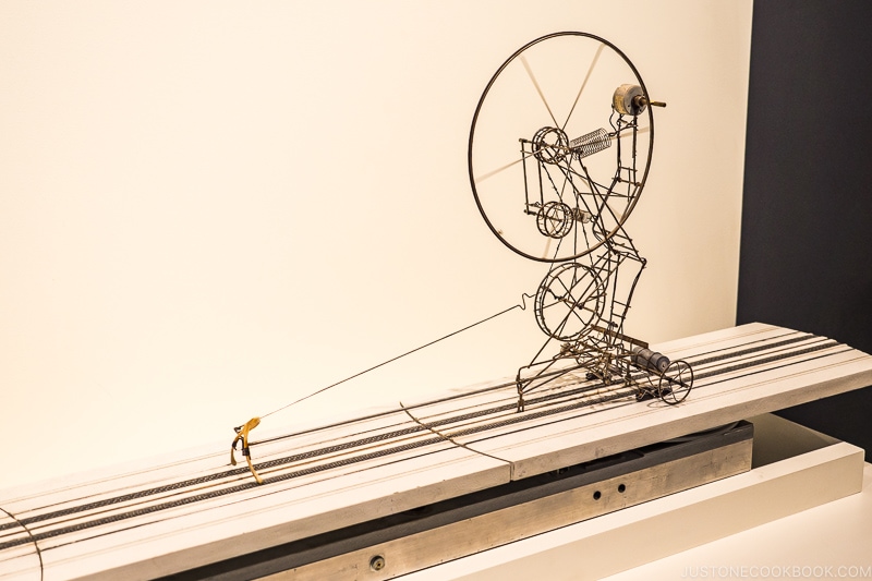 exhibition at MIT Museum with a wishbone pulling a metal structure