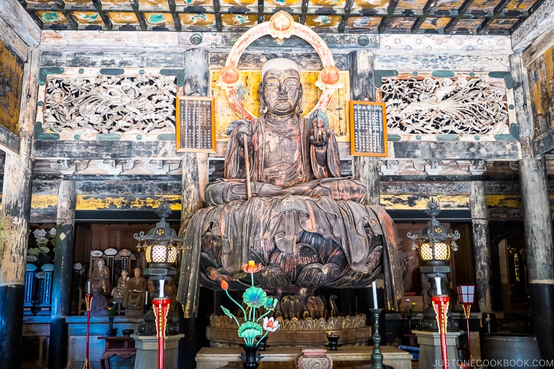 an old statue of deity sitting on lotus