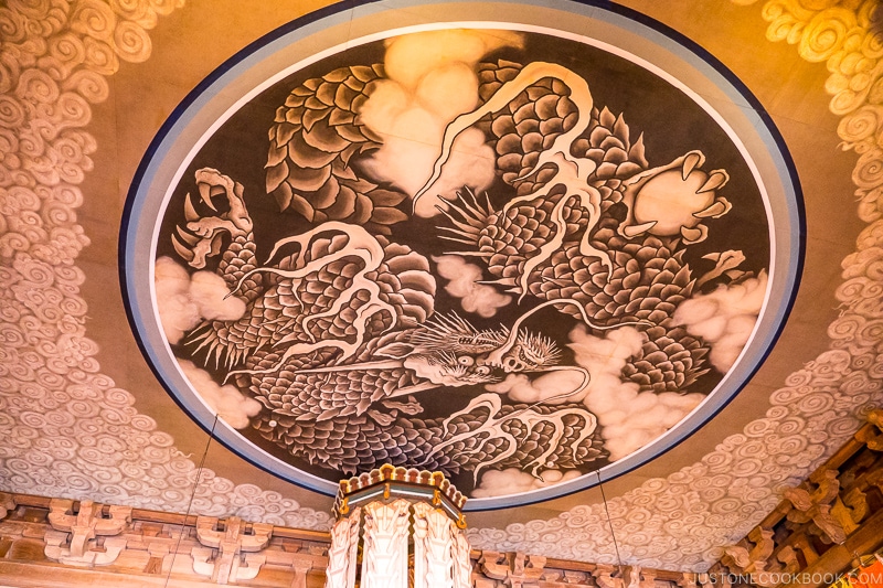 image of a dragon in clouds in a circle on the ceiling