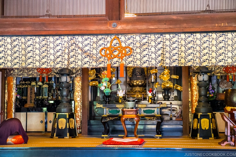 a deity statue on lotus on an altar
