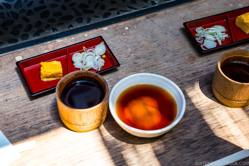 somen sauce next to green onion on a table