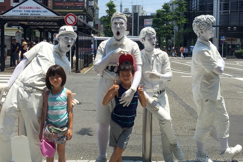 two children with people covered in white paint