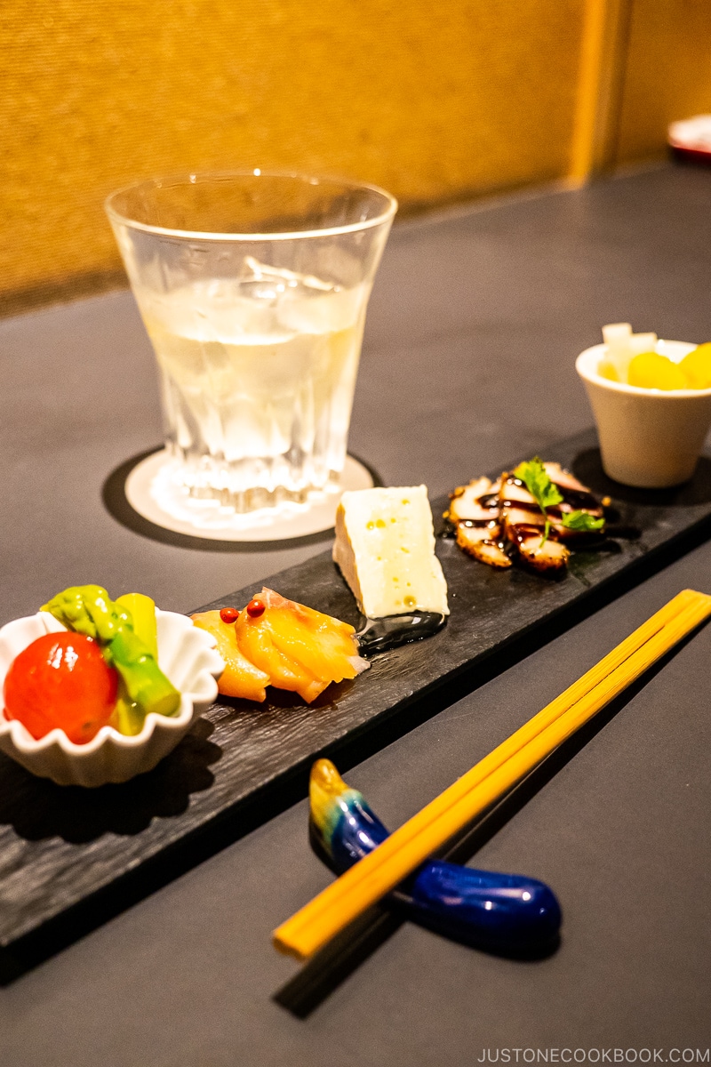 appetizers on a long narrow plate and a drink on the table at Parfait, coffee, liquor, Sato in Sapporo