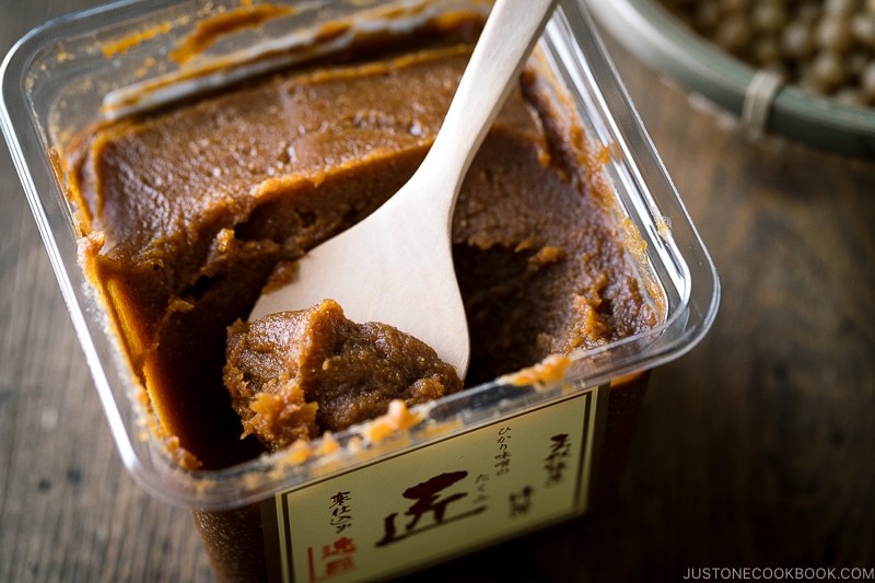 tub of miso with a wooden spoon