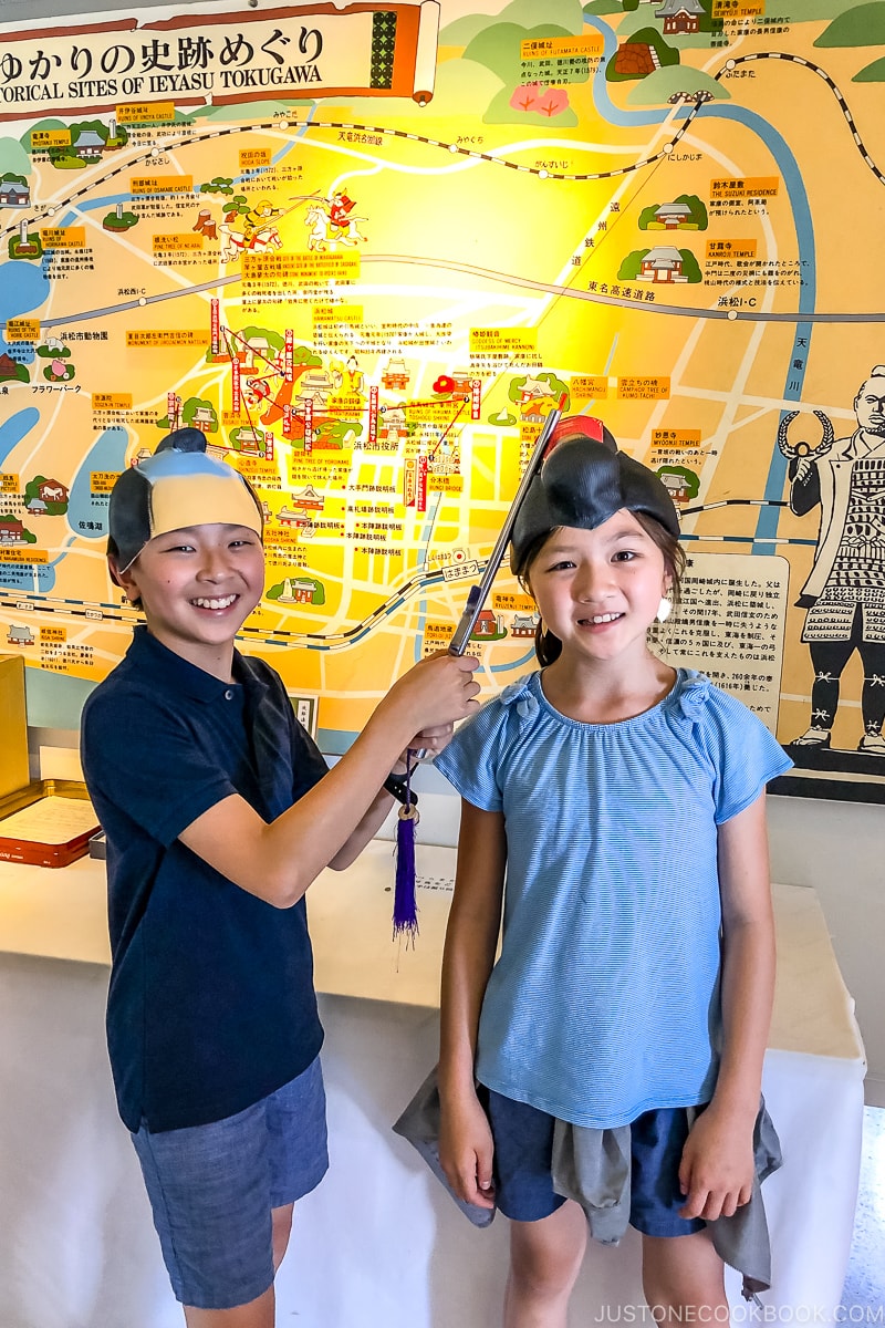 a boy and a girl in traditional Japanese wigs