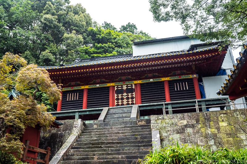 steps leading up to a red and black shrine building