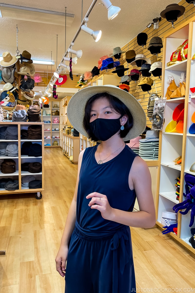 a girl inside a hat store