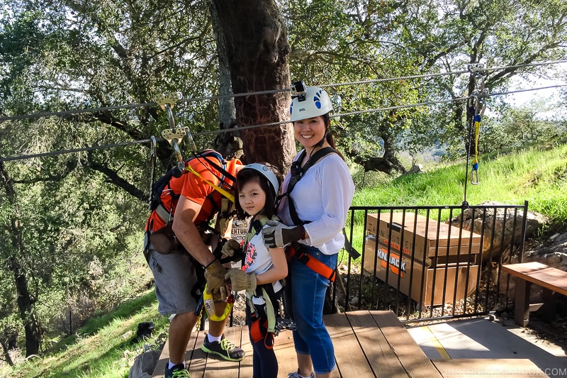 a woman and a girl getting ready to zipline