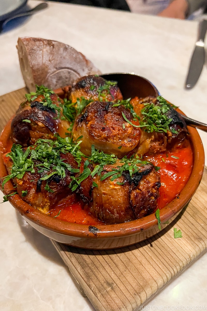 chorizo-stuffed medjool dates with bacon and piquillo pepper-tomato sauce