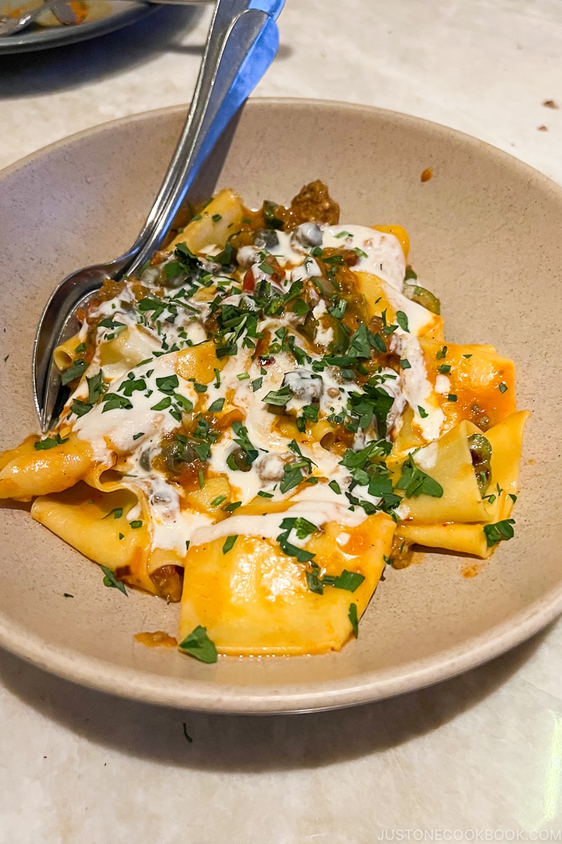 pappardelle with beef heart bolognese, capers, grilled olives and parmesan fonduta