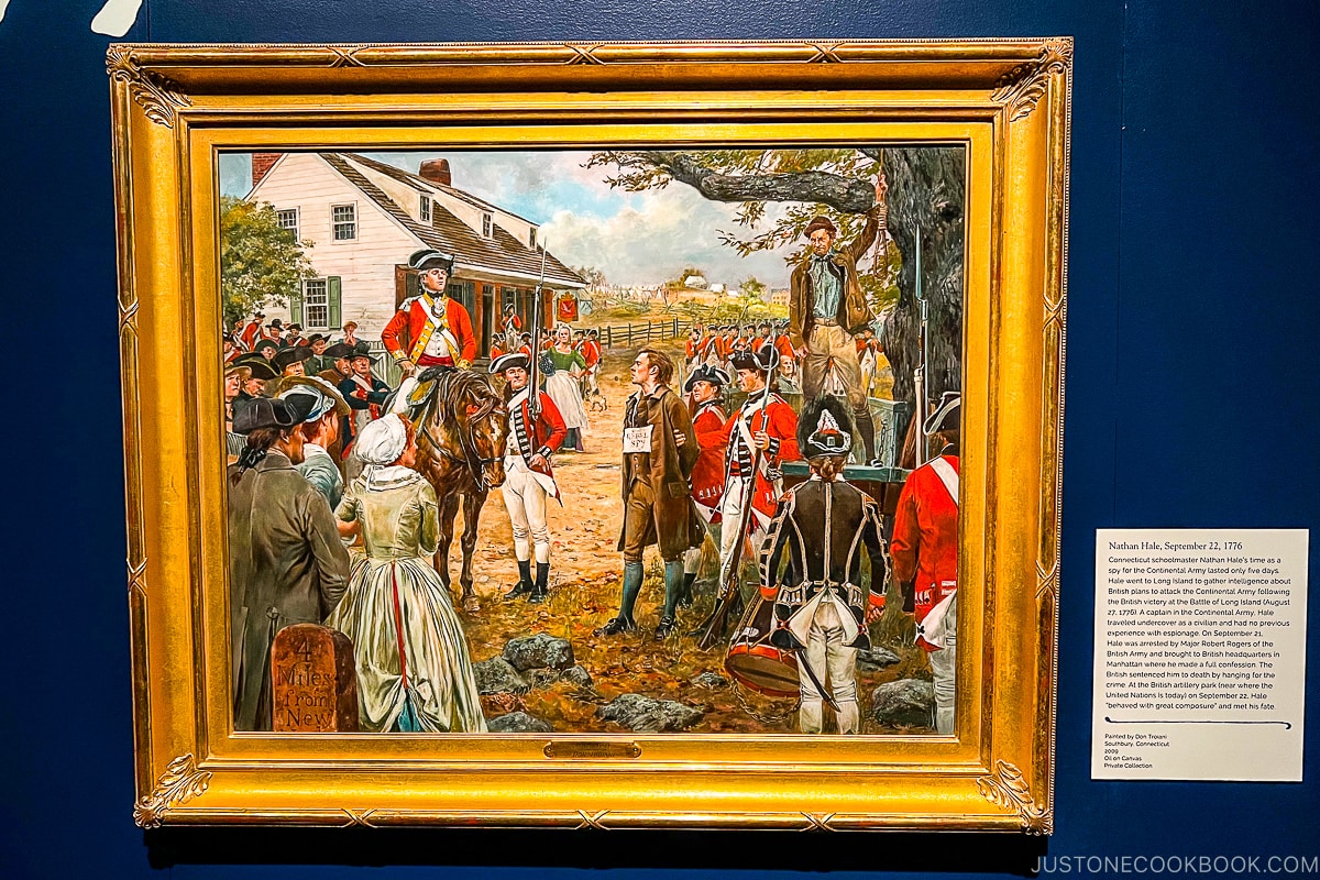 framed painting on a blue wall