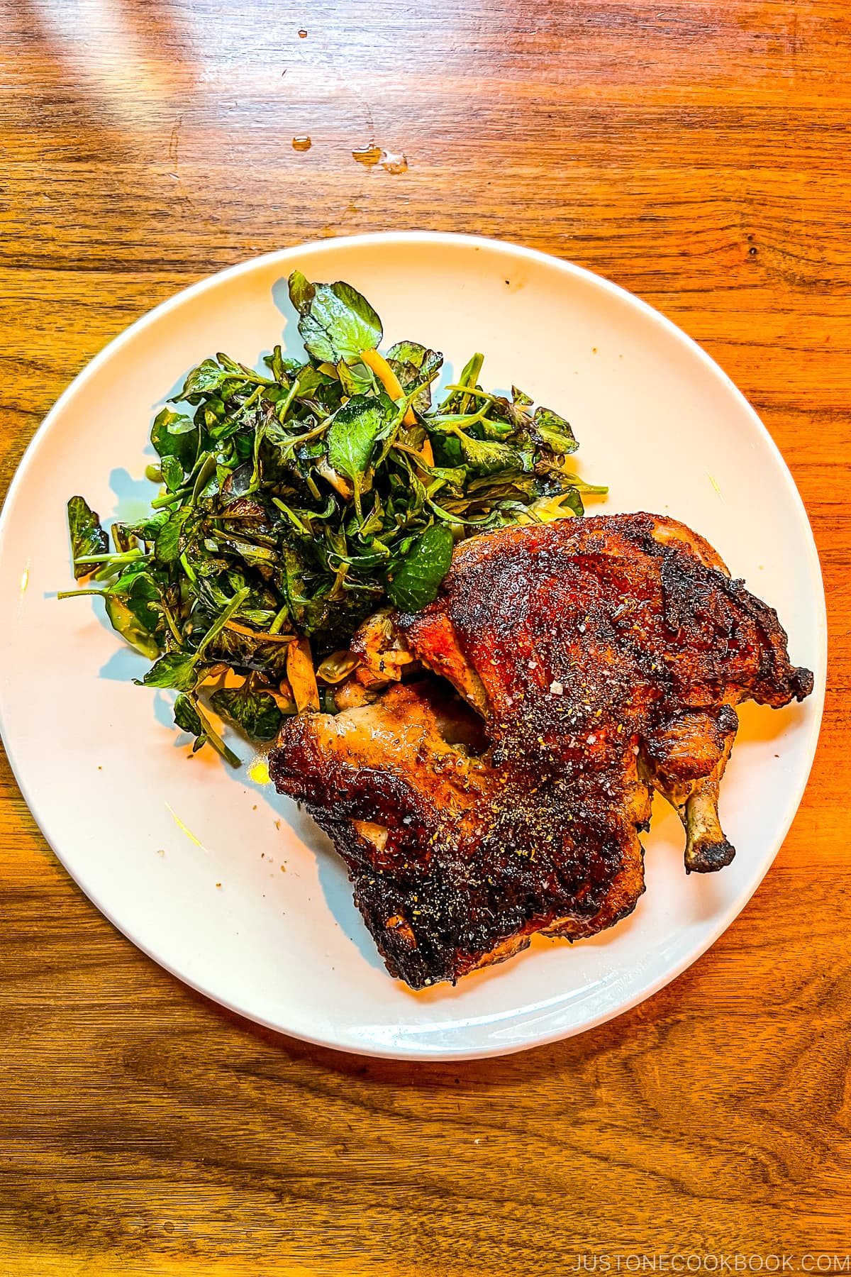 wood fired Whole Spring Chicken on a white plate