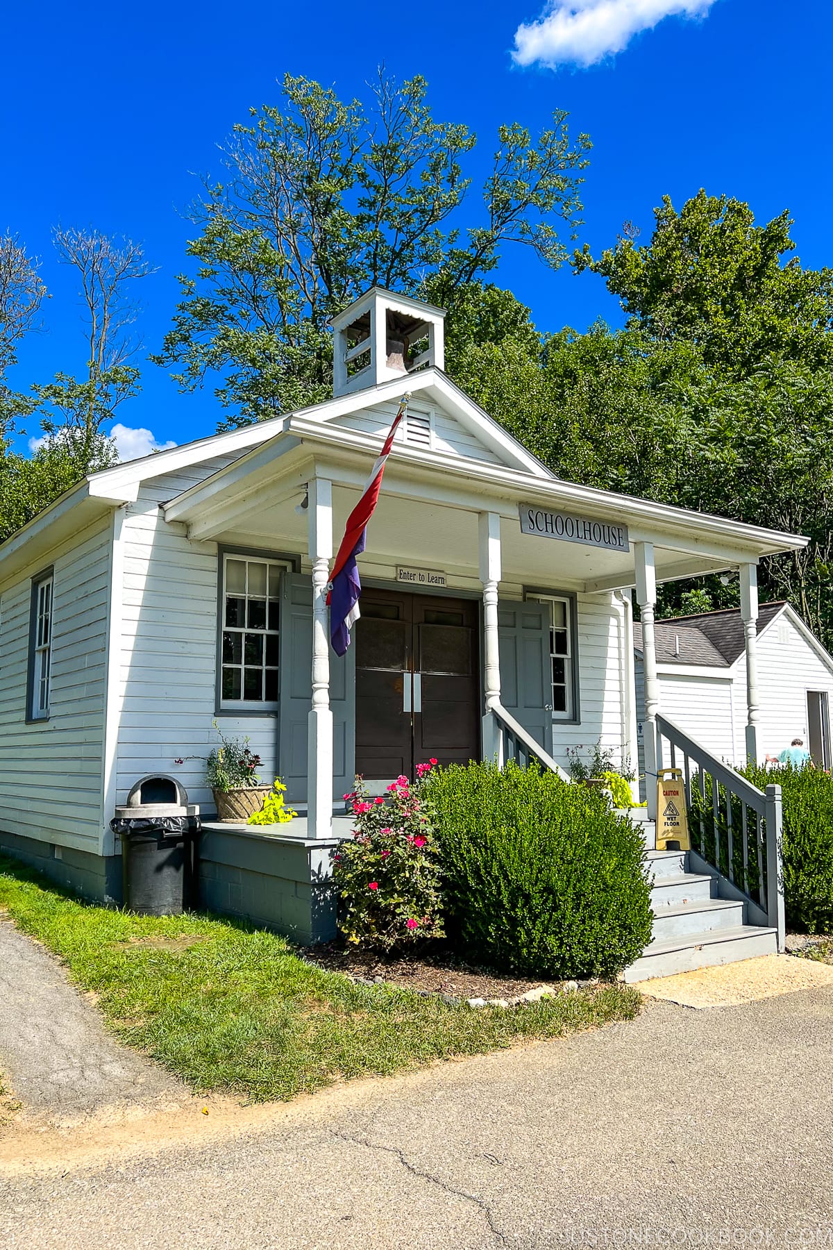 a white building with schoolhouse sign