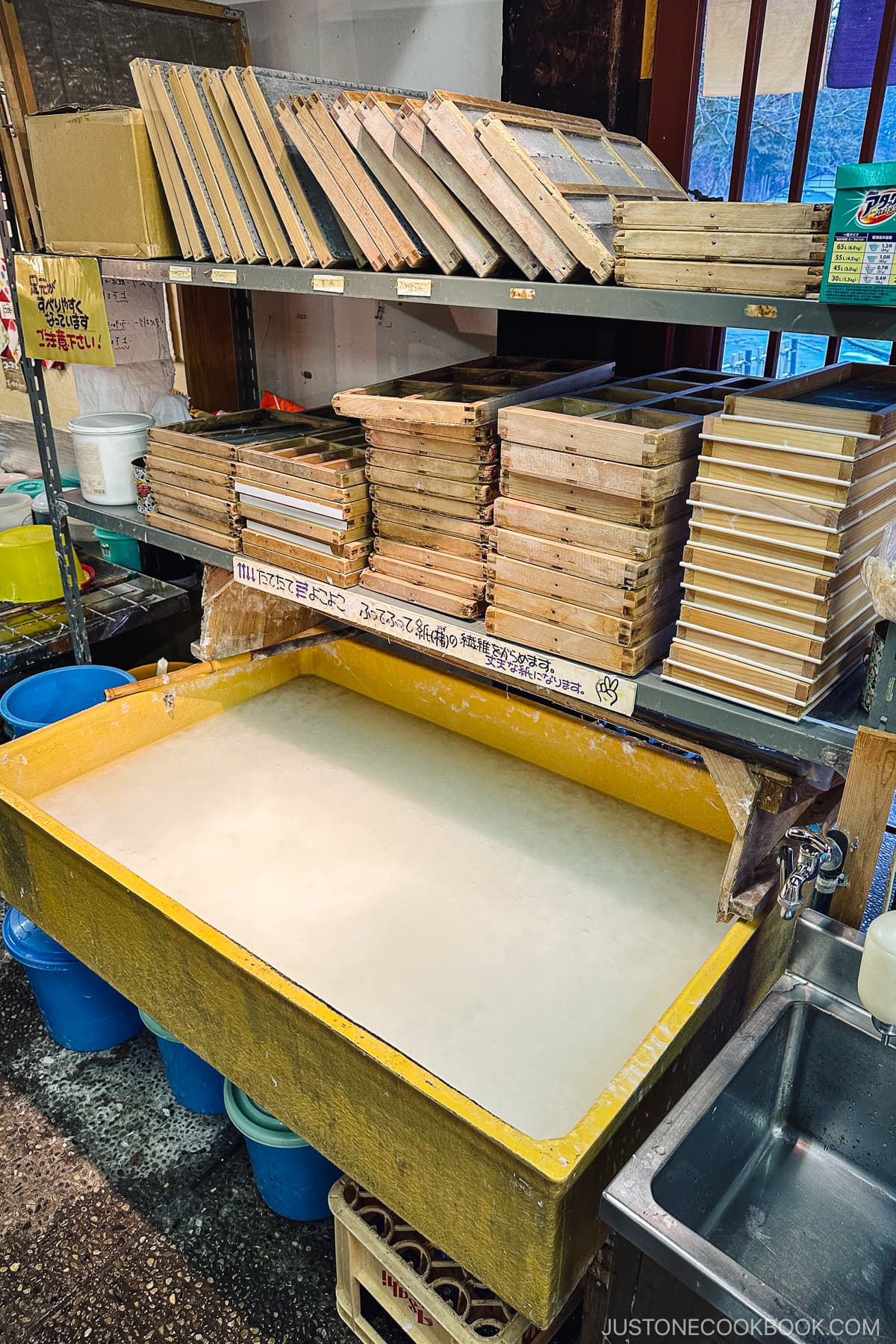 wood trays on top of a tub of milky water