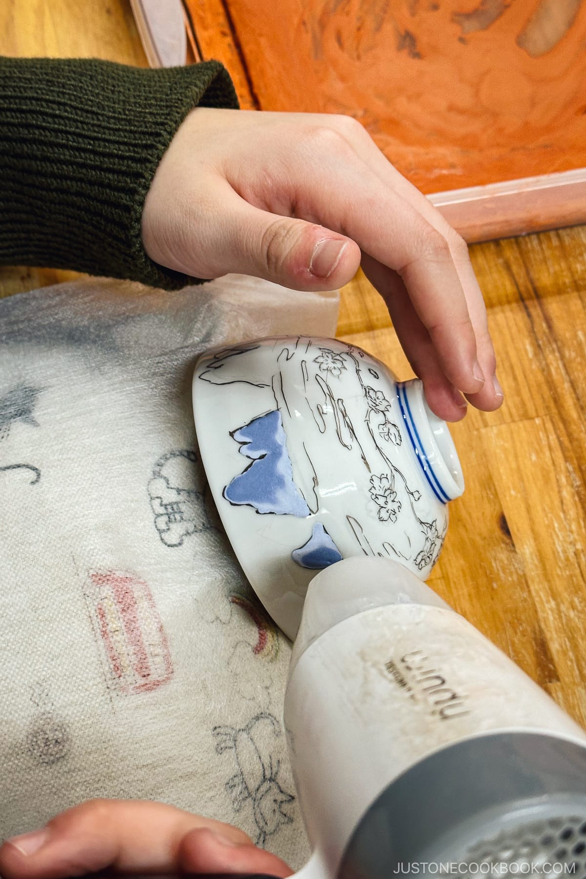 using a dryer to dry the ink on a porcelain bowl