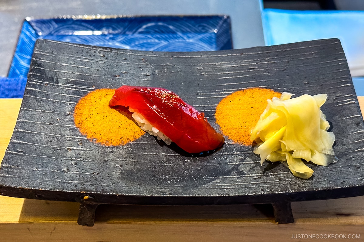 tuna sushi on a black plate