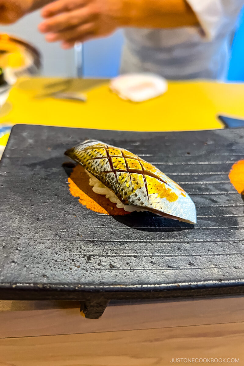 sushi on a black plate