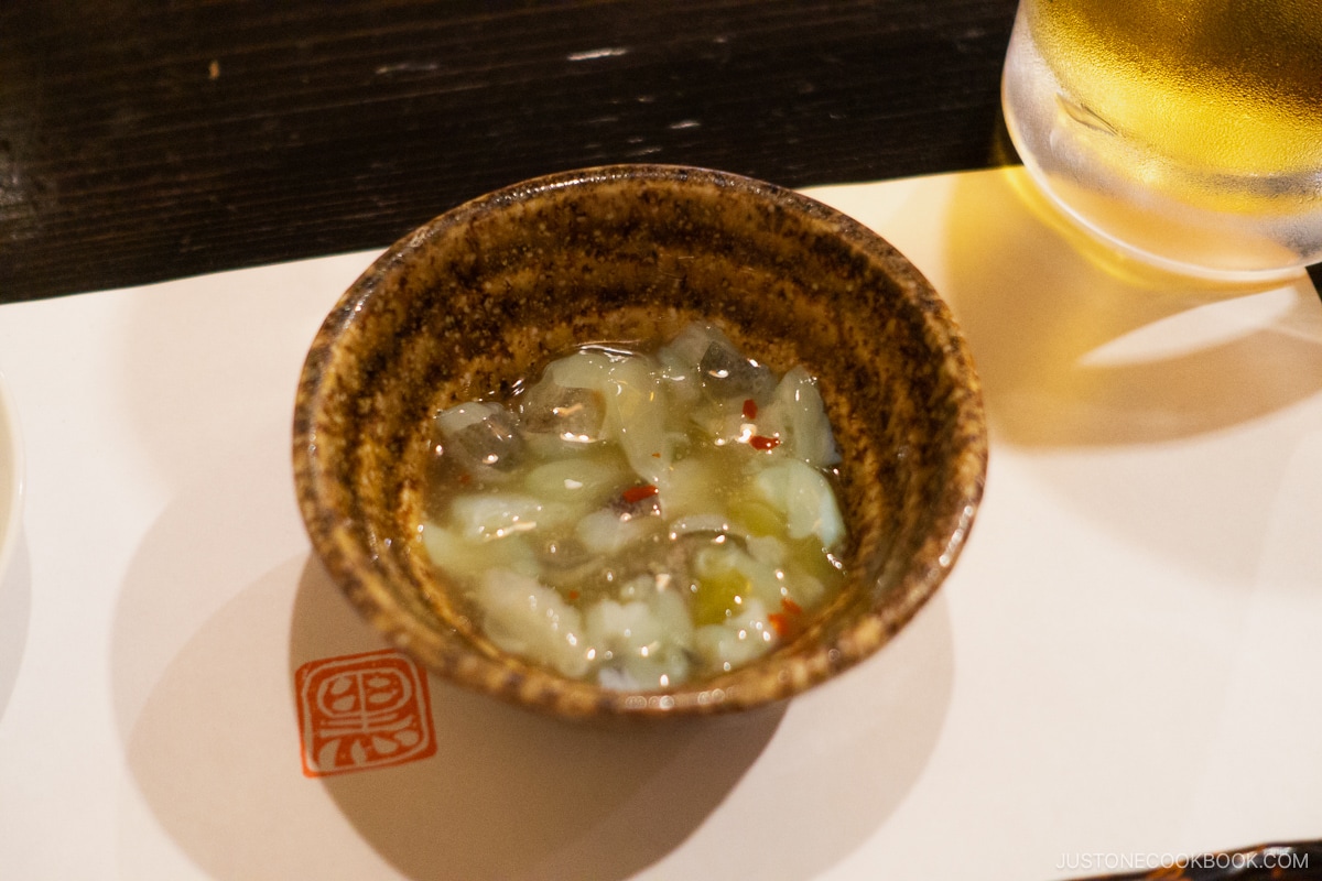 Complimentary starter dish of raw octopus and wasabi dressing