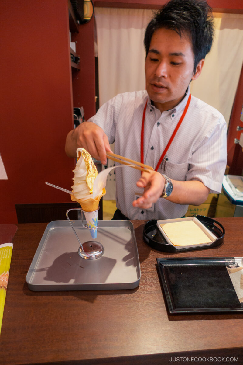 Placing gold leaf on to ice cream