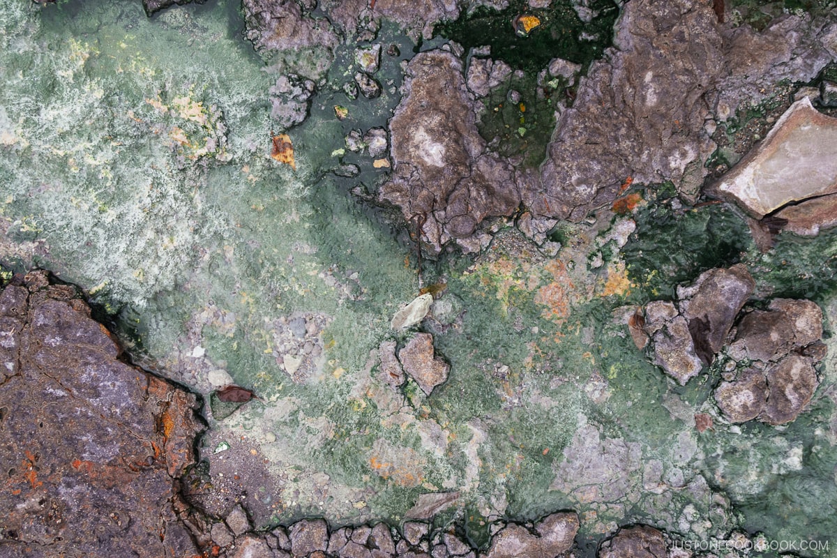 Rocks stained from sulfur from Kawayu Onsen Foot Bath