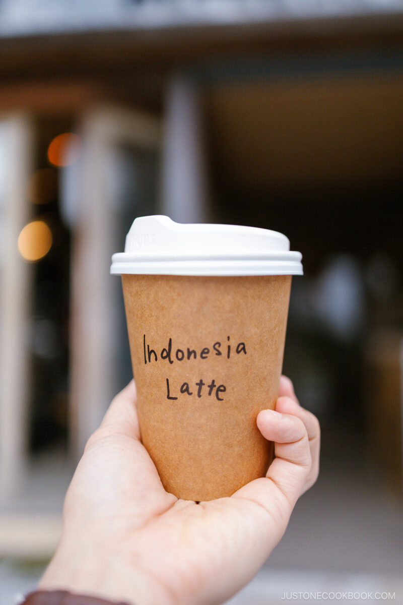 Holding a takeout coffee cup