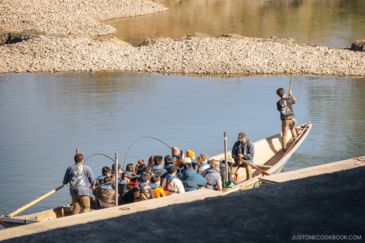 Boat boarding area with a bridge and mountains in the background