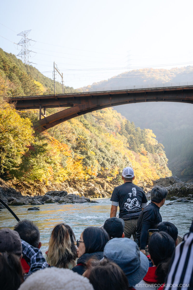 Boat about to go through river rapids surrounded by mountains