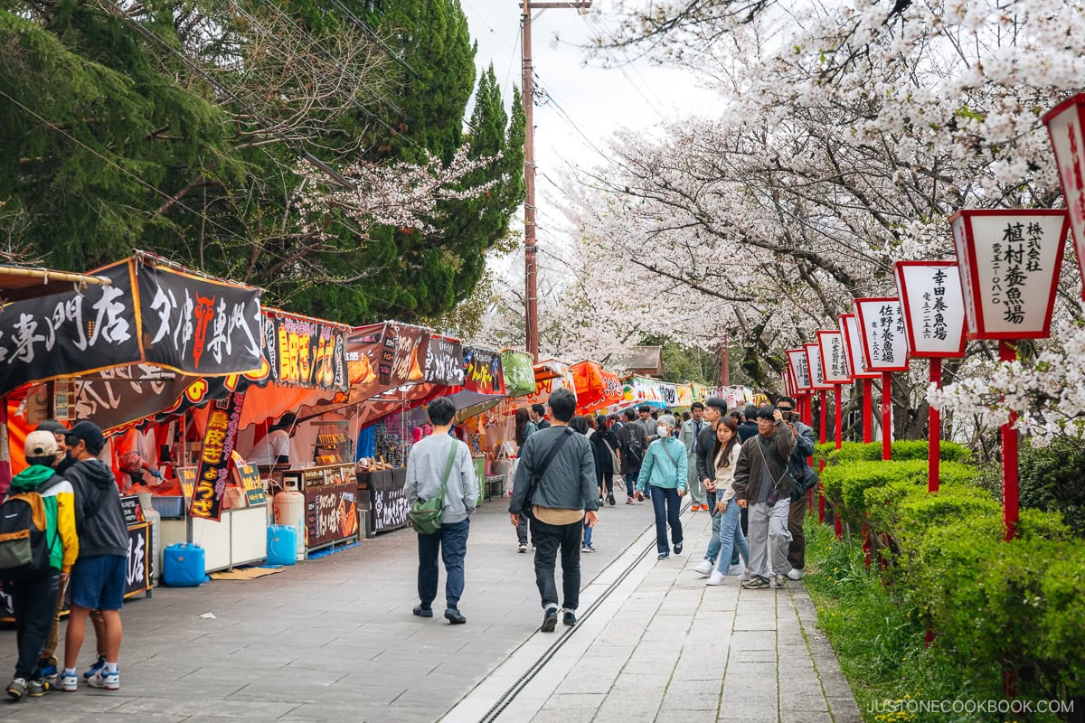 Food stalls next to cherry blossoms