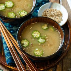 Miso soup bowls containing Natto and Okra Miso Soup topped with sesame seeds.