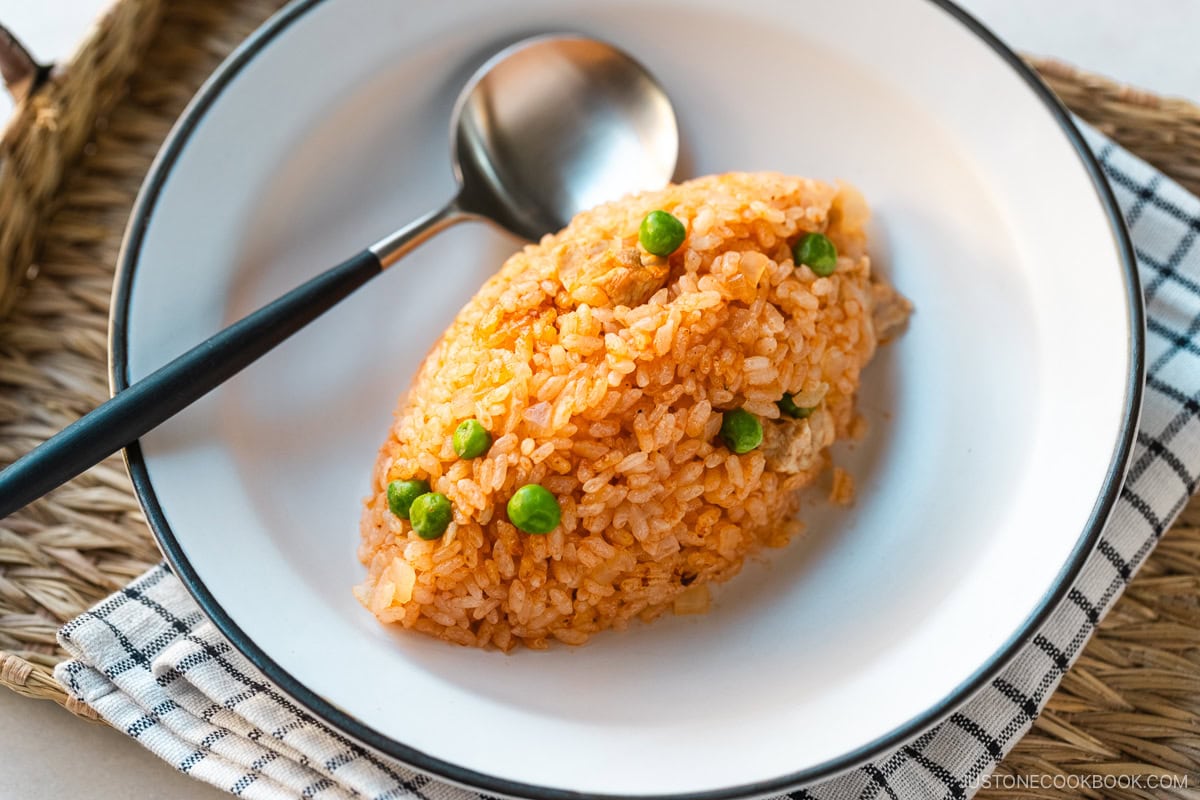 A plate containing Chicken Rice, seasoned with Japanese ketchup and Worcestershire sauce.