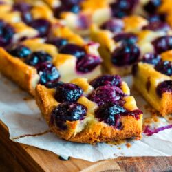 Cherry bards on top of a wooden cutting board.