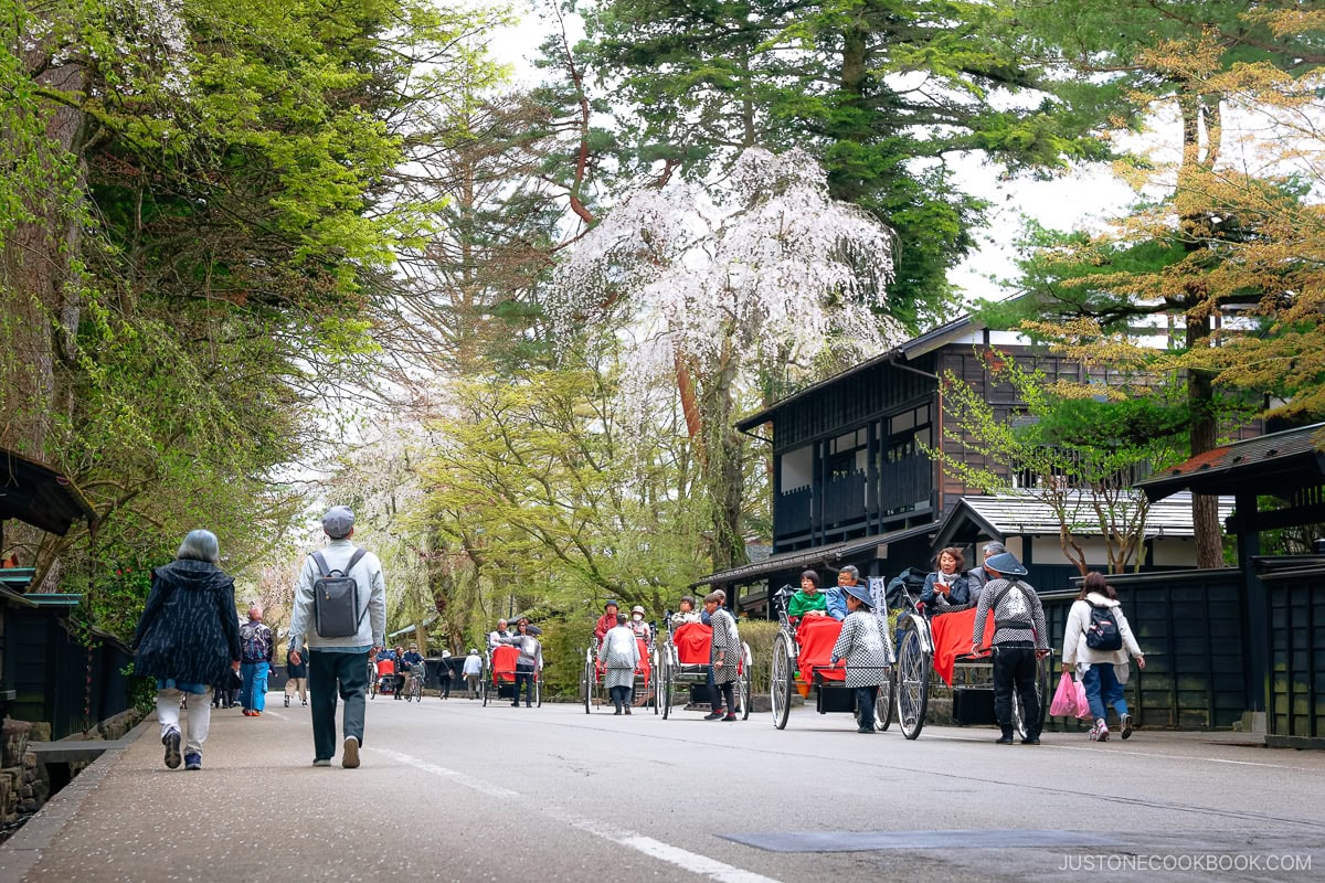 Old samurai town with people being pulled in carts