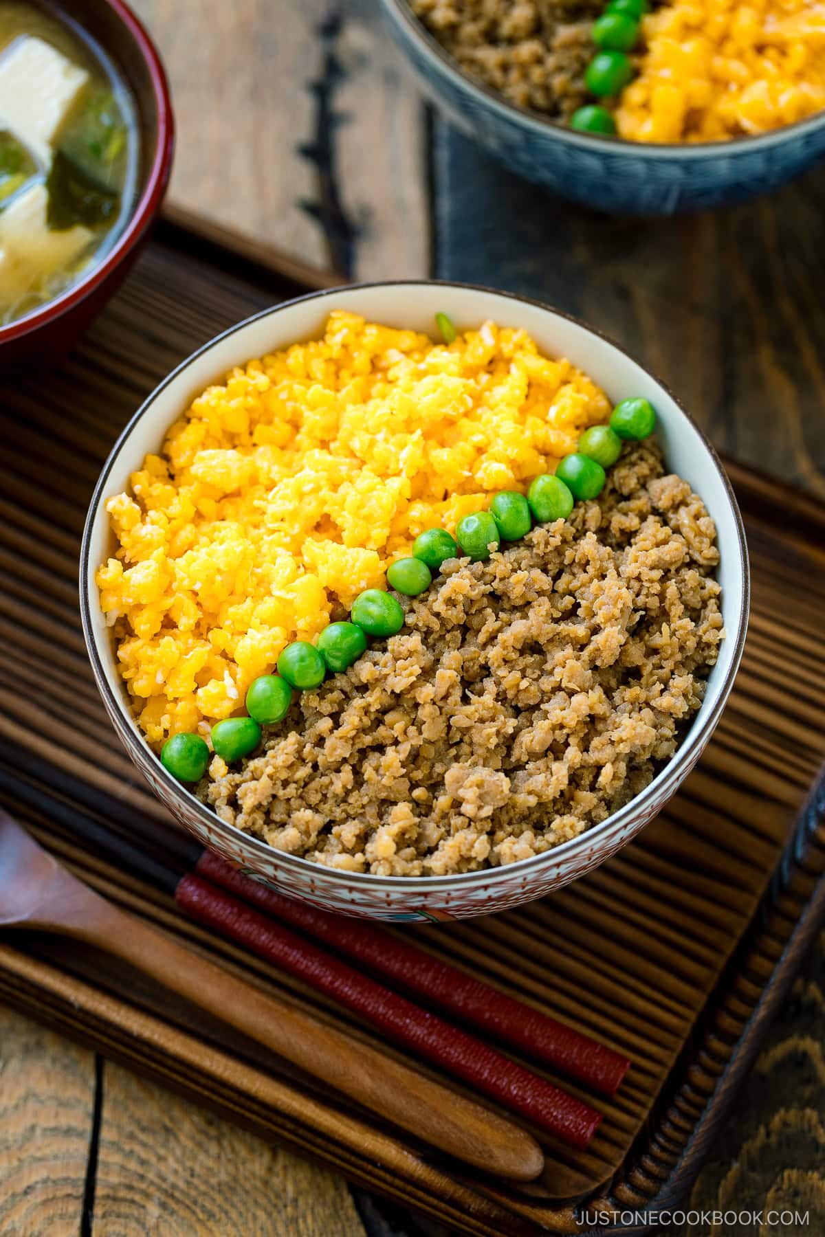 A bowl containing Soboro Don (seasoned ground chicken and scrambled egg over rice).