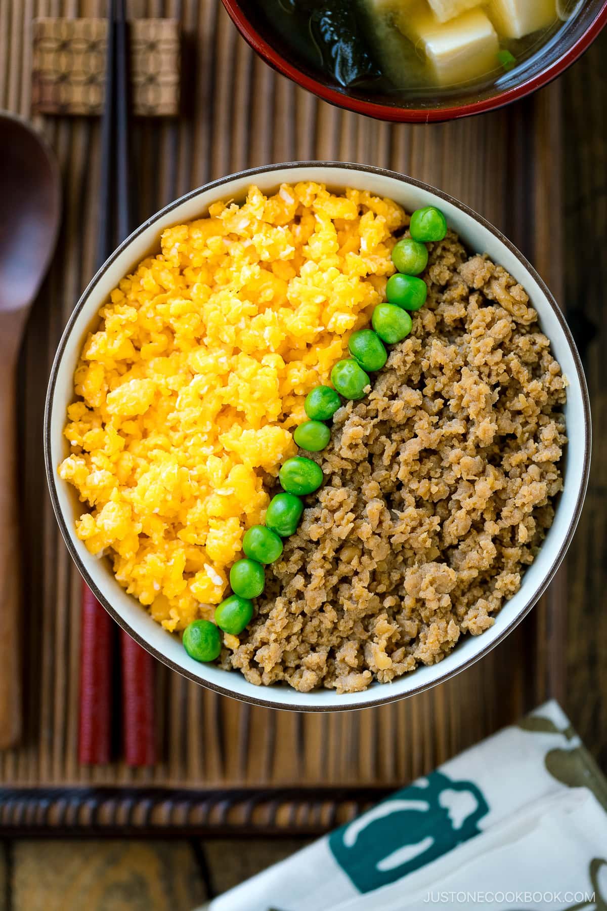 A bowl containing Soboro Don (seasoned ground chicken and scrambled egg over rice).