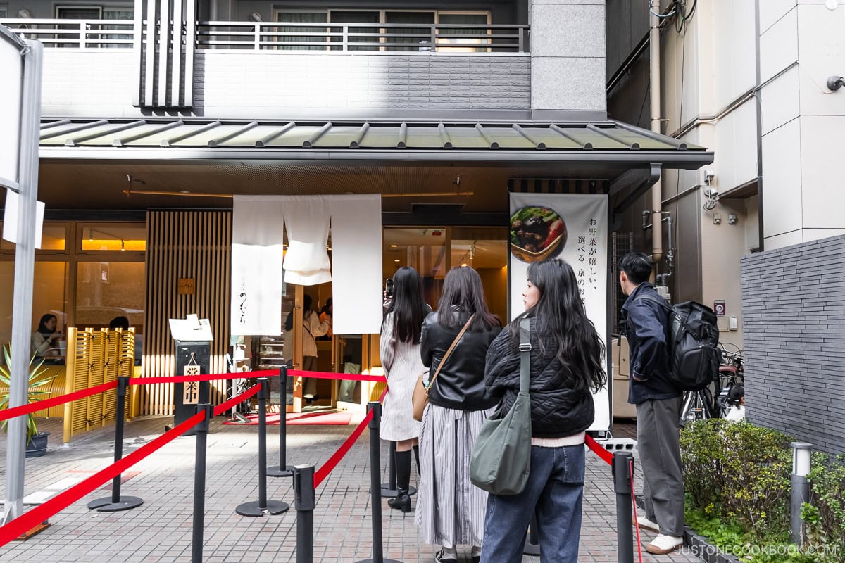 People lining outside restaurant