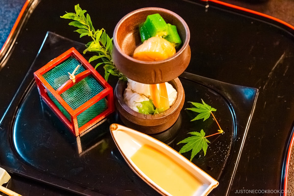 dishes in small dishes in a black tray