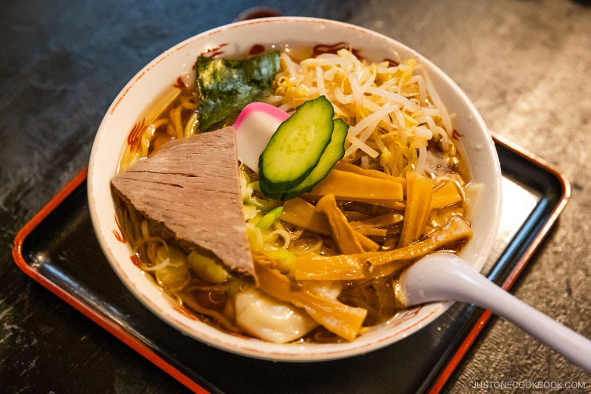 Cold ramen with ice cubes, topped with vegetables and chashu pork