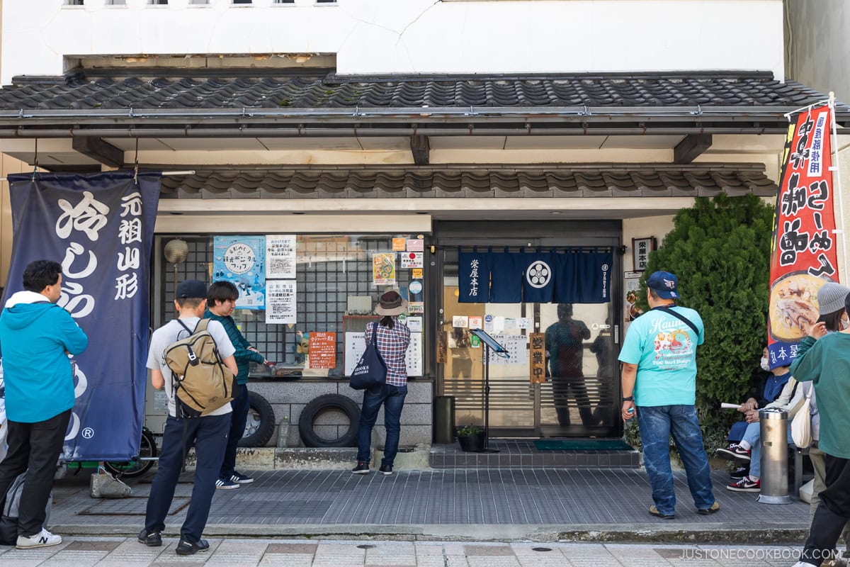 People waiting outside a restaurant
