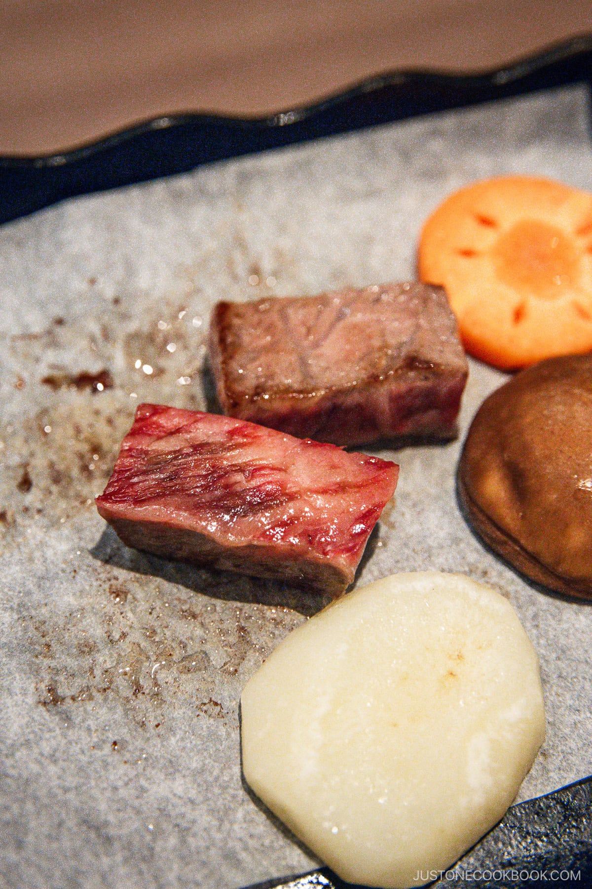 Beef being cooked on a stone plate