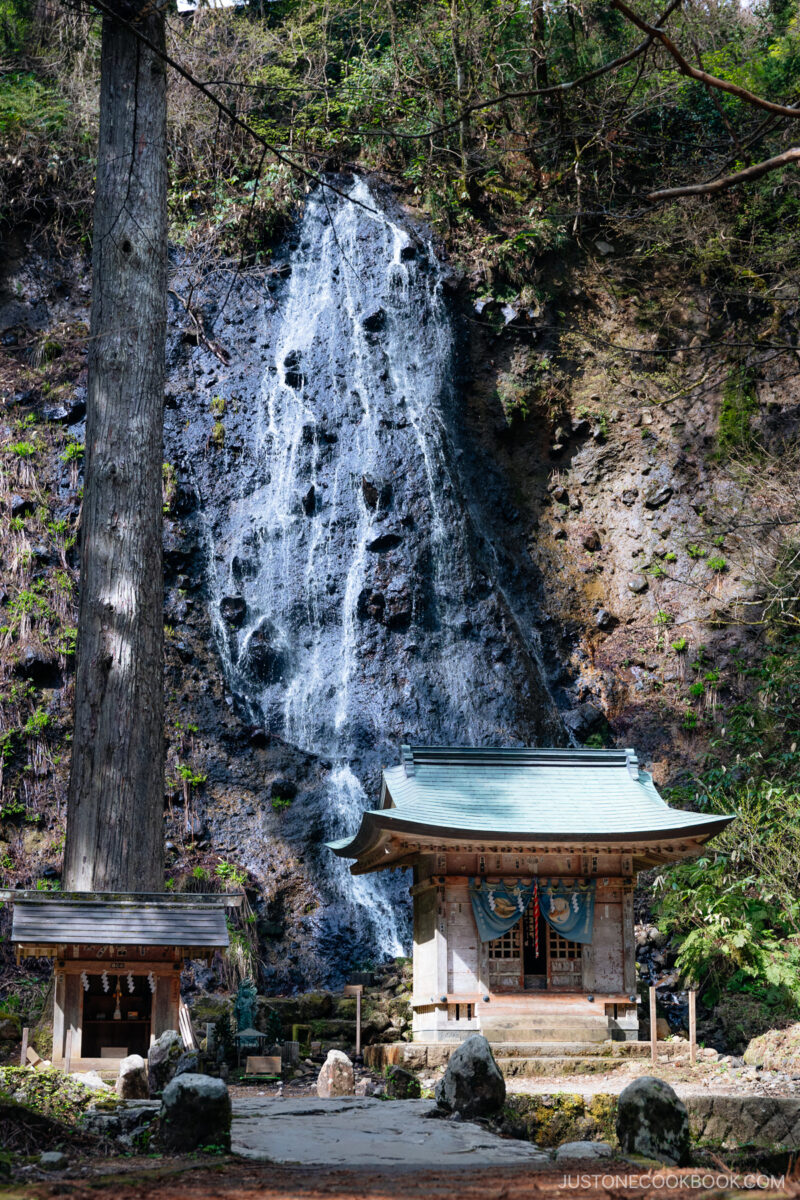 Small waterfall with wooden shrines