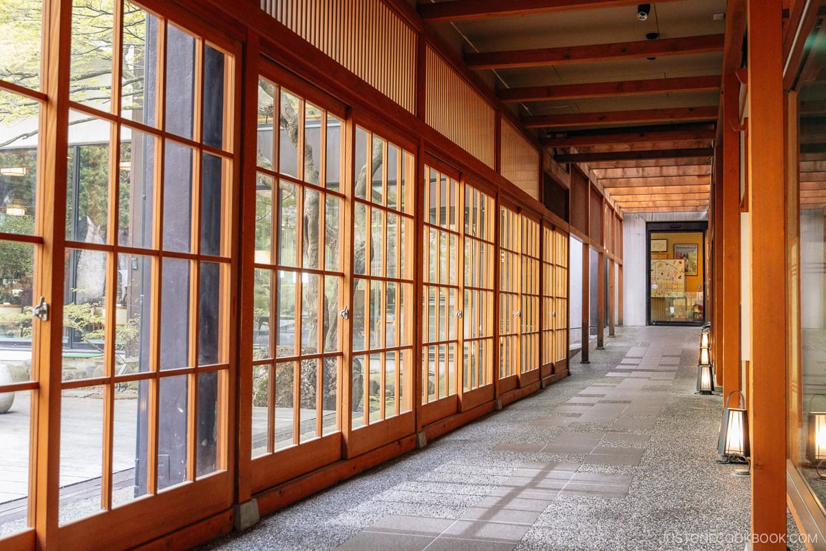 Hotel corridor with wooden doors and stone walkway